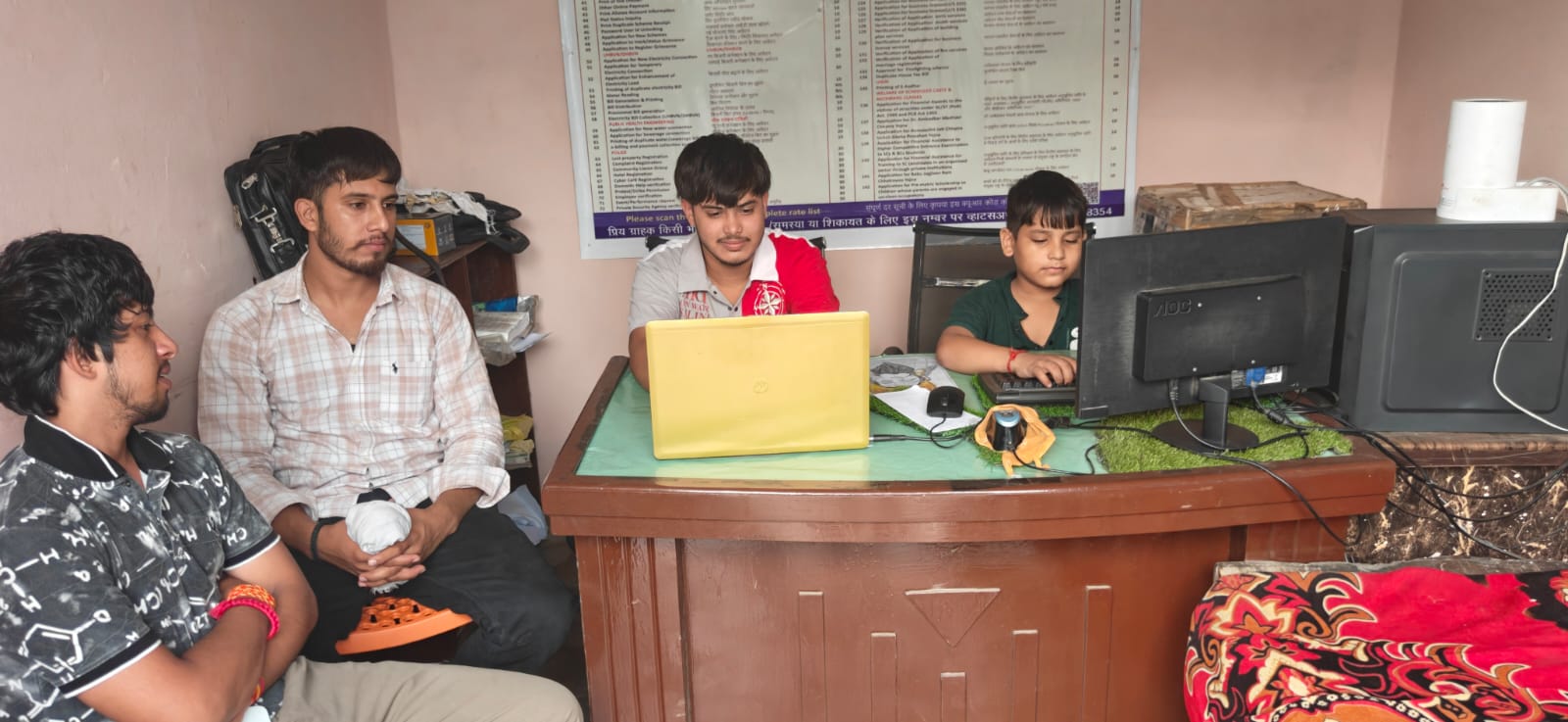 Staff assisting customers at the Laxita Online Services counter